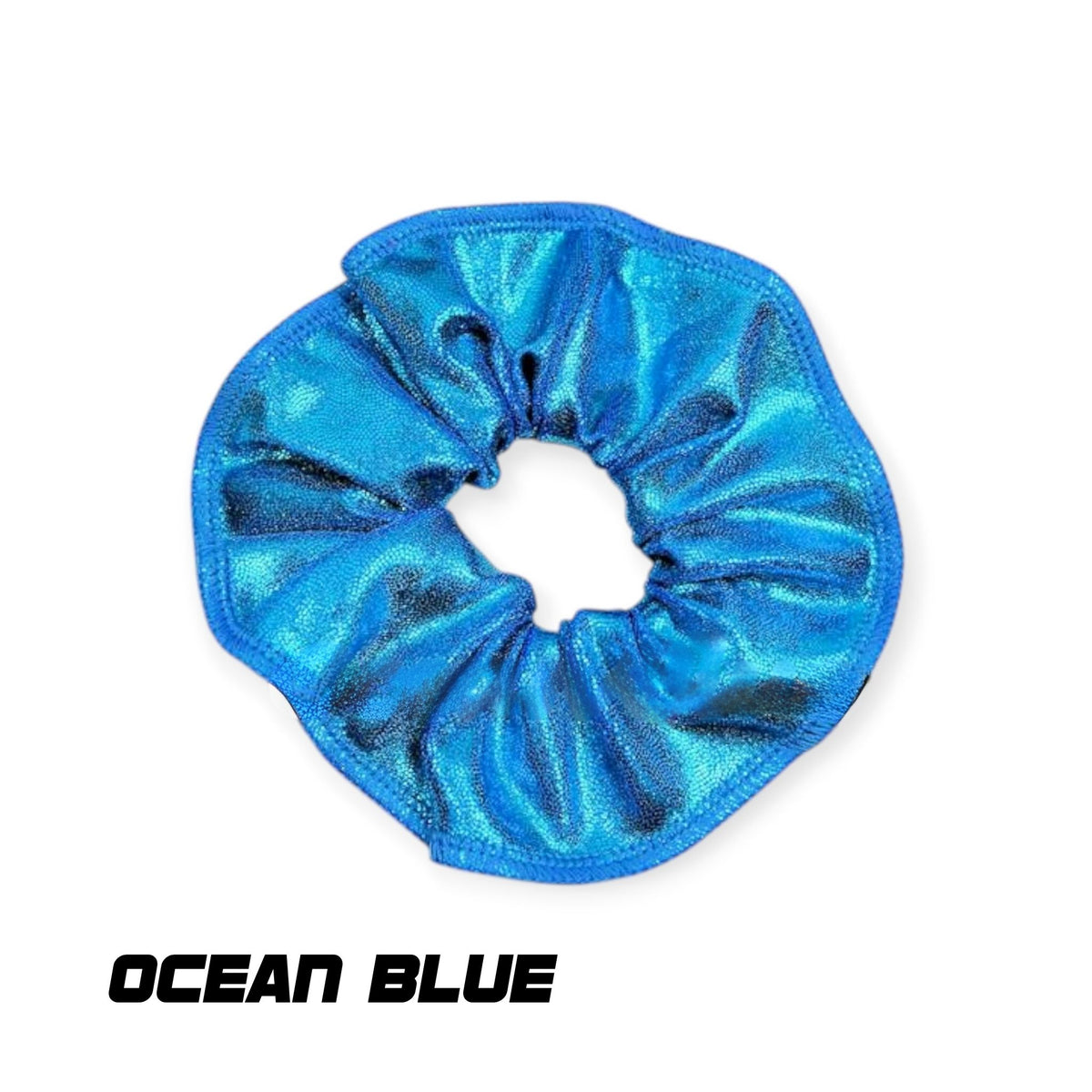 A shiny metallic blue scrunchie with a textured, pleated fabric design, shown on a white background with the text 'OCEAN BLUE' underneath.